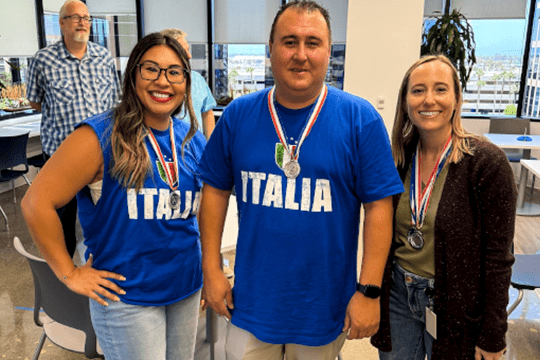 3 people wearing medals at the Office Olympics